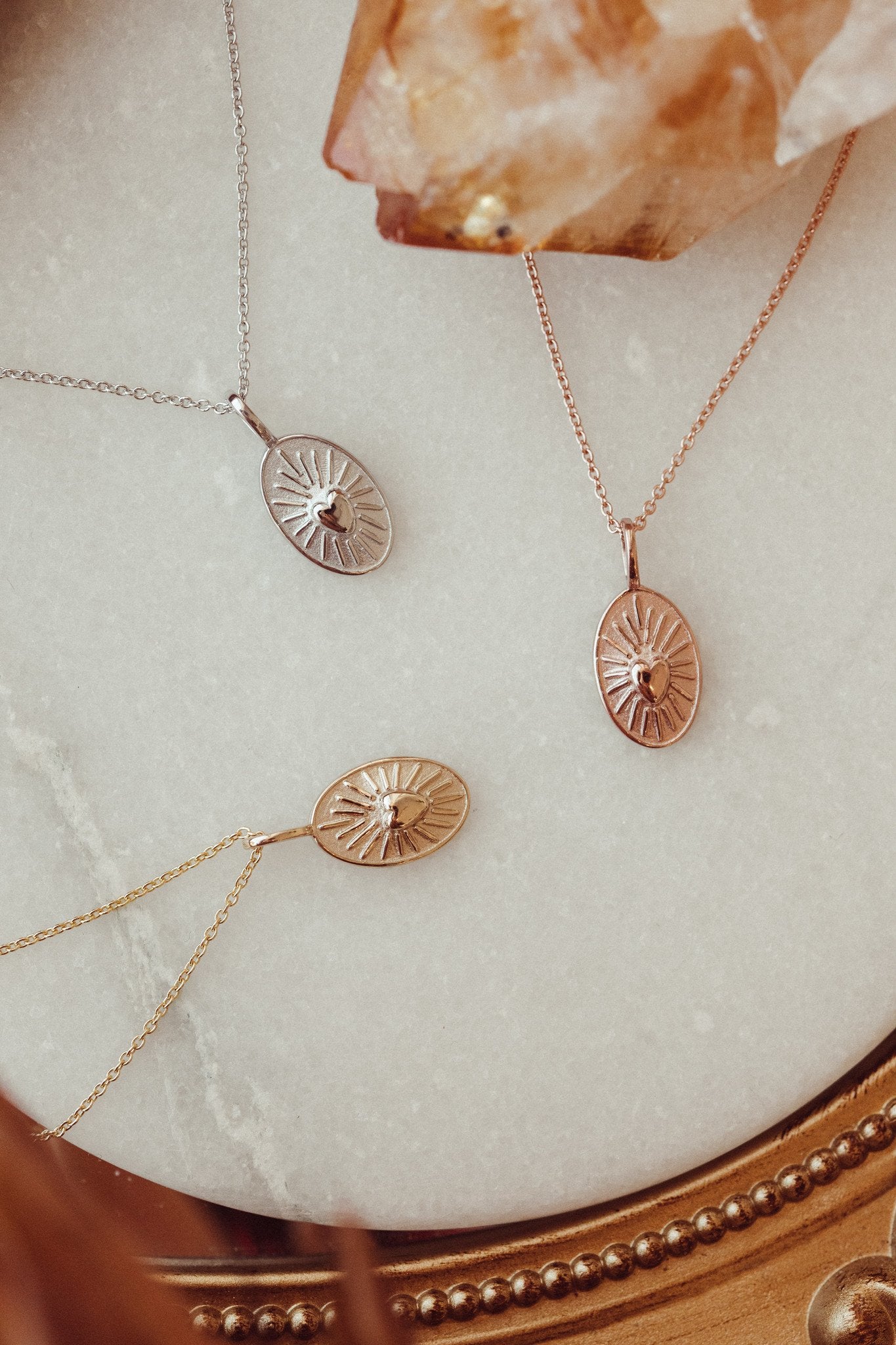 Gold necklace with a heart charm in 14k yellow, white, and rose gold