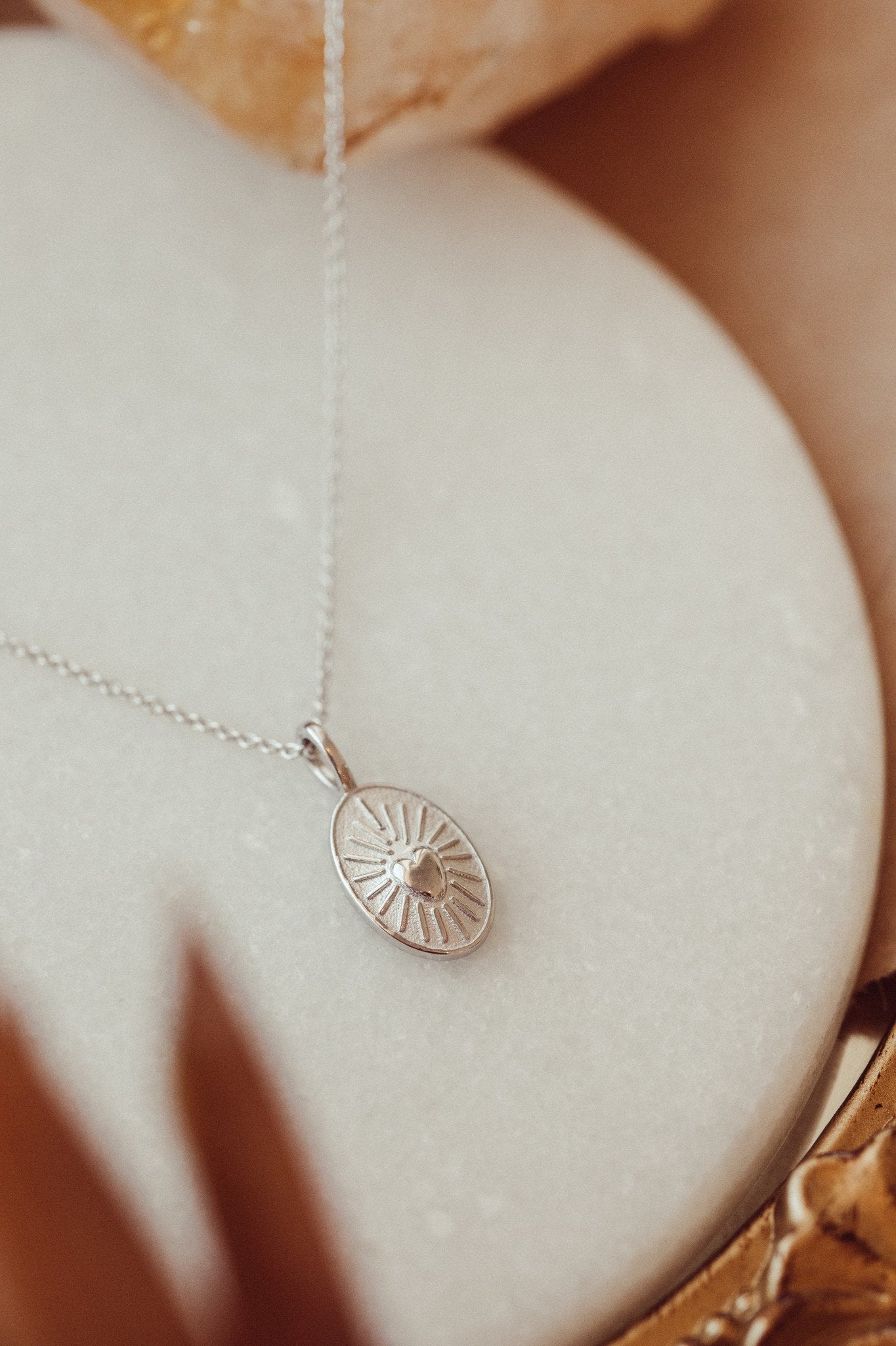 Gold necklace with a heart charm in 14k white gold