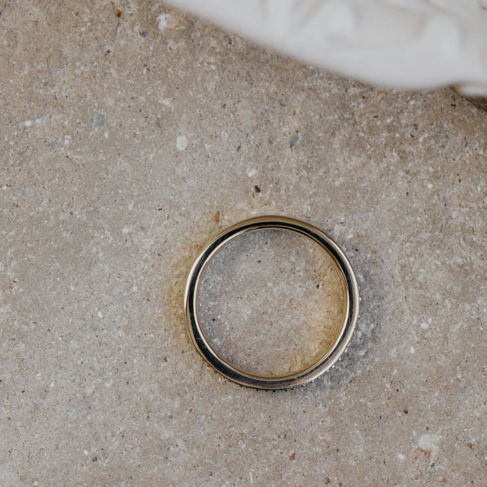 Gold band on a textured concrete surface