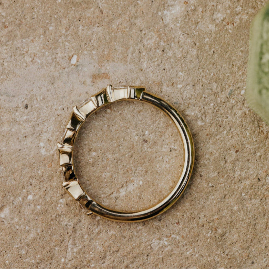 Gold band on a textured beige surface