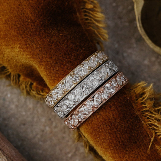 Close-up of a diamond-encrusted ring on a textured brown surface
