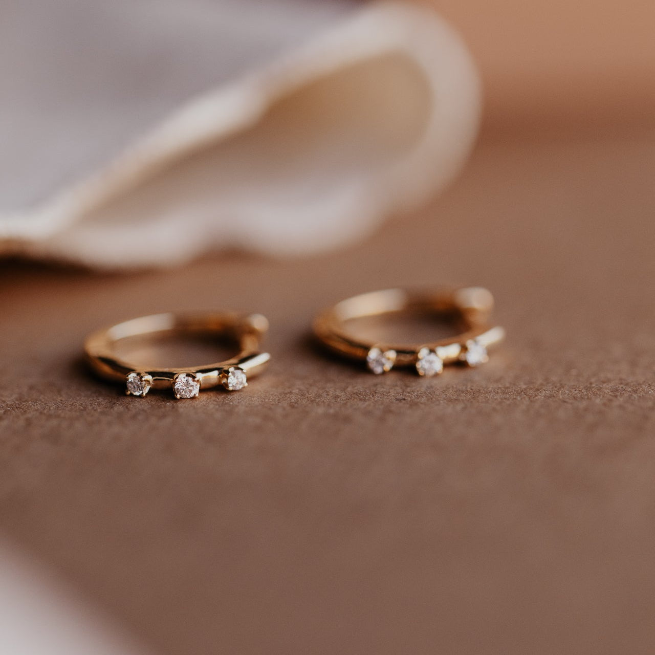 Three Prong Set Round Diamonds on Huggie Earrings