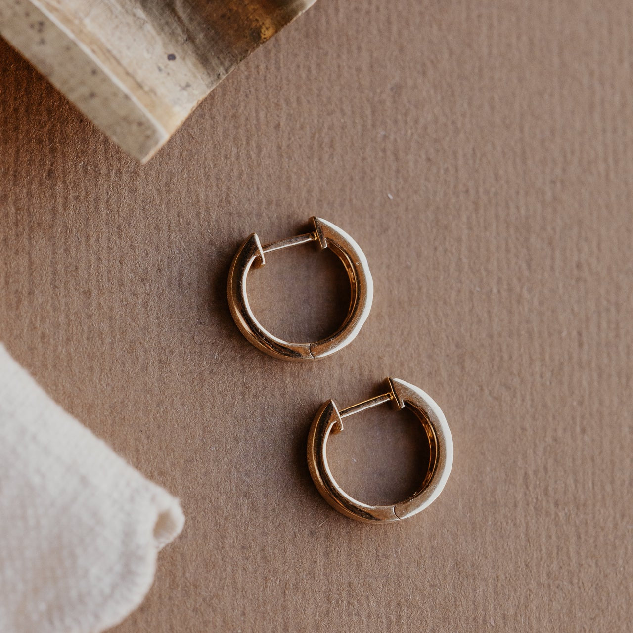 Aerial view of the Three Hammer Set Round Diamonds on Hoop Earrings