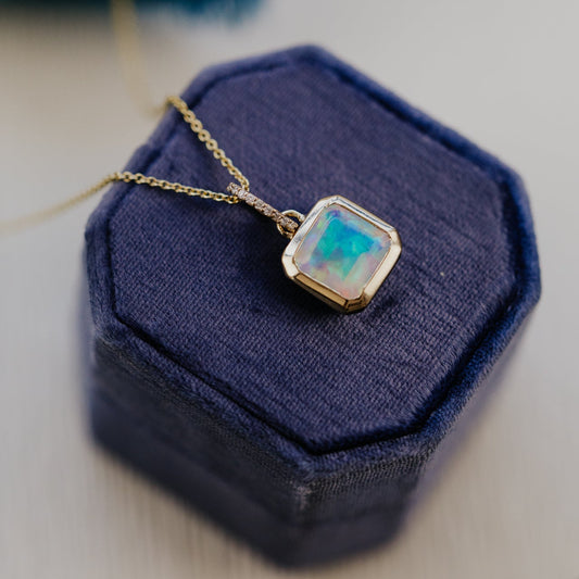 Necklace with a square Opal pendant on a blue jewelry box