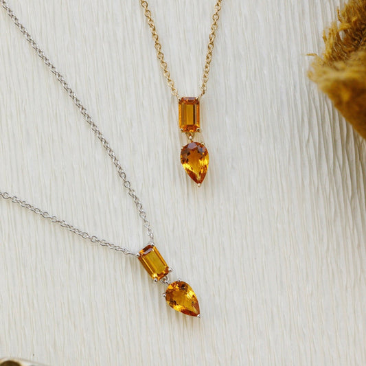 Necklace with amber-colored citrine gemstones on a textured surface