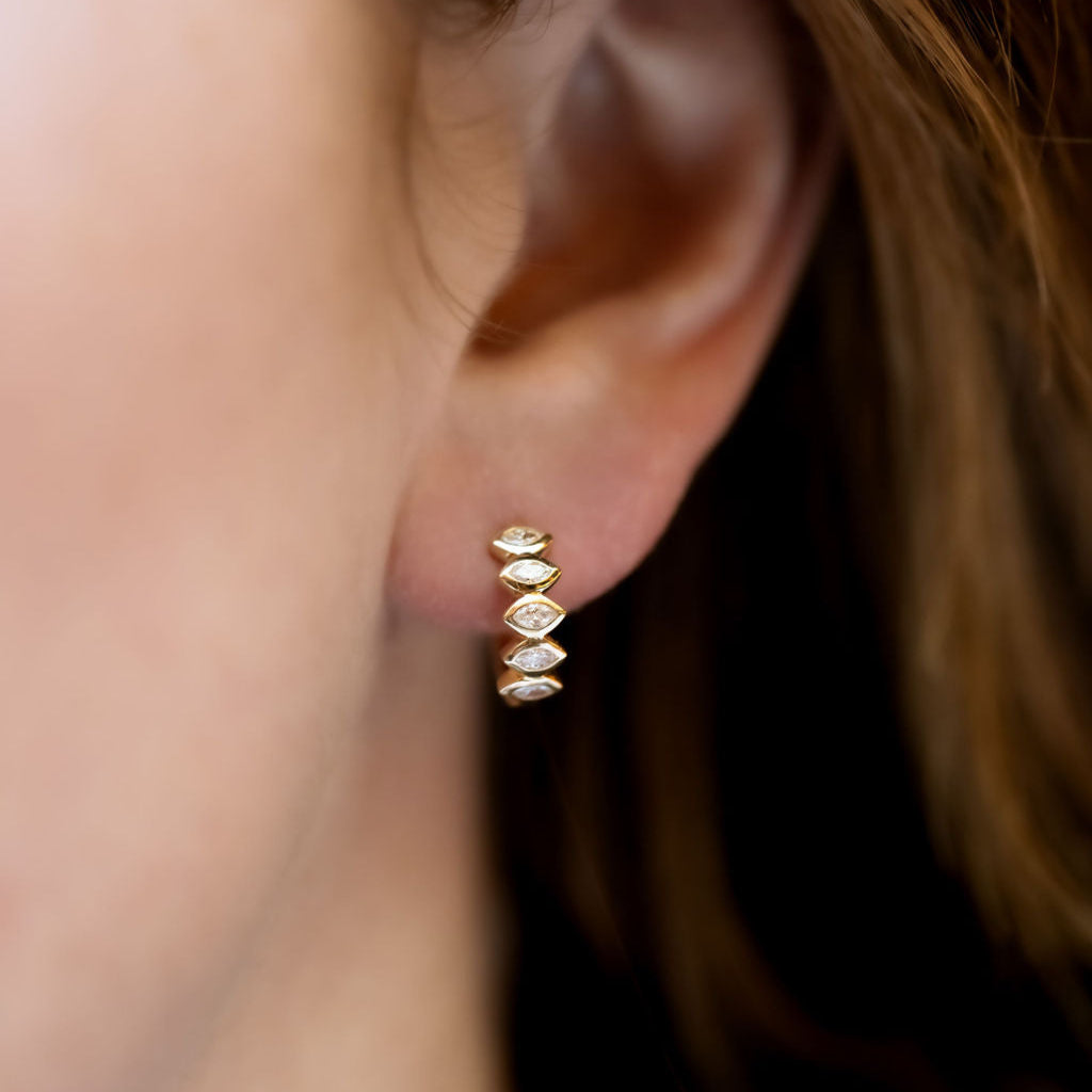 Marquise Bezel Set Diamond Huggie Earrings on models ear