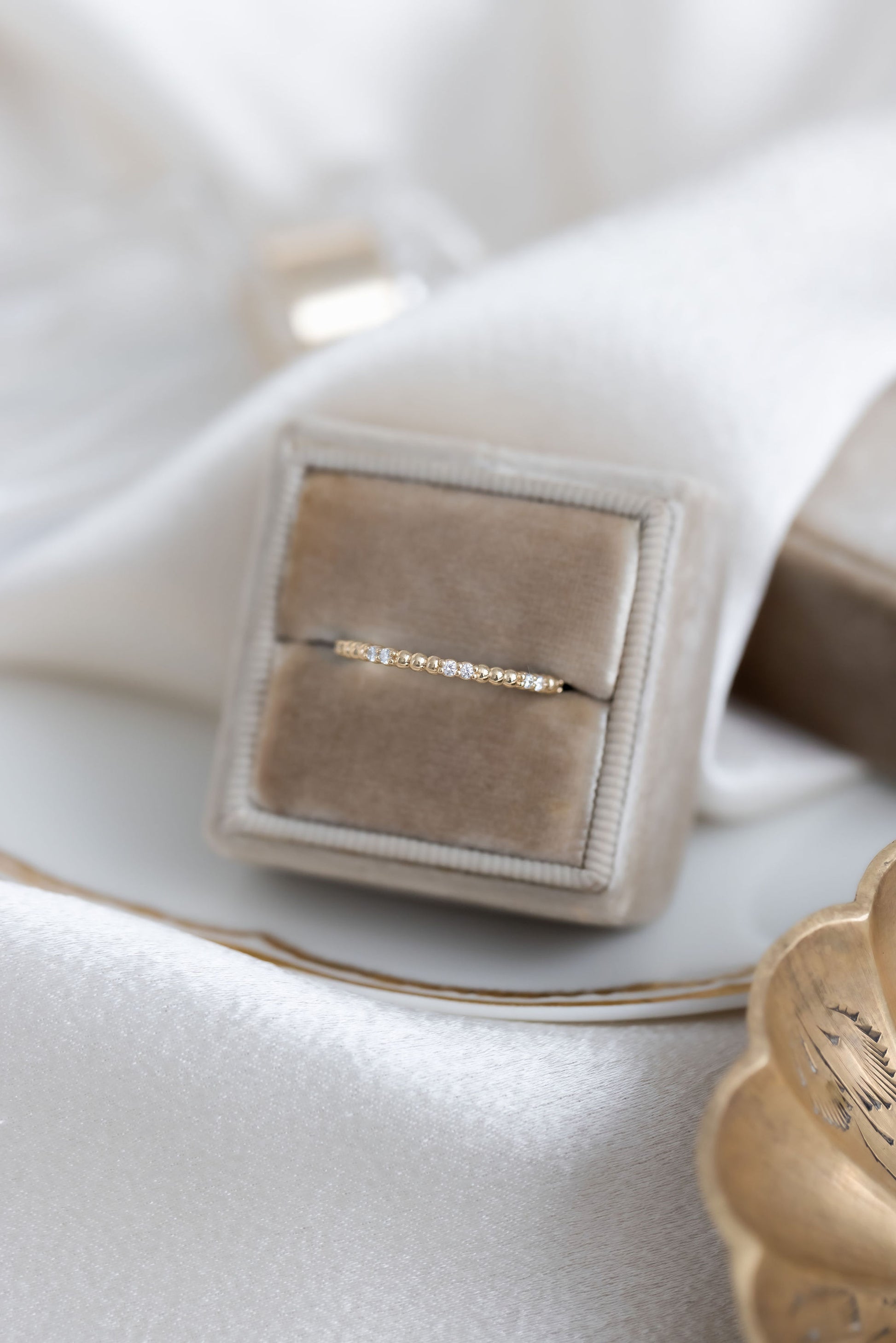 The Jackie Diamond Band in 14k yellow gold in a Sarah O Jewelry velvet ring box