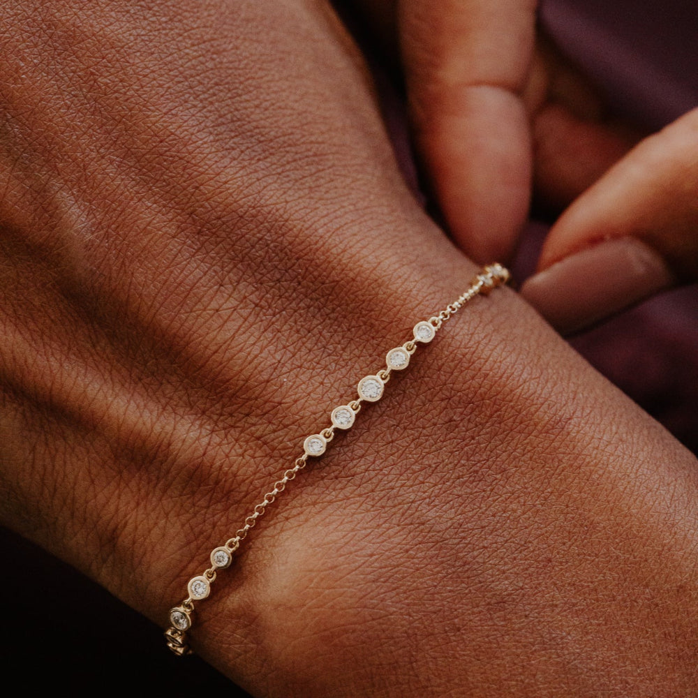 Gold bracelet with small diamonds on a wrist