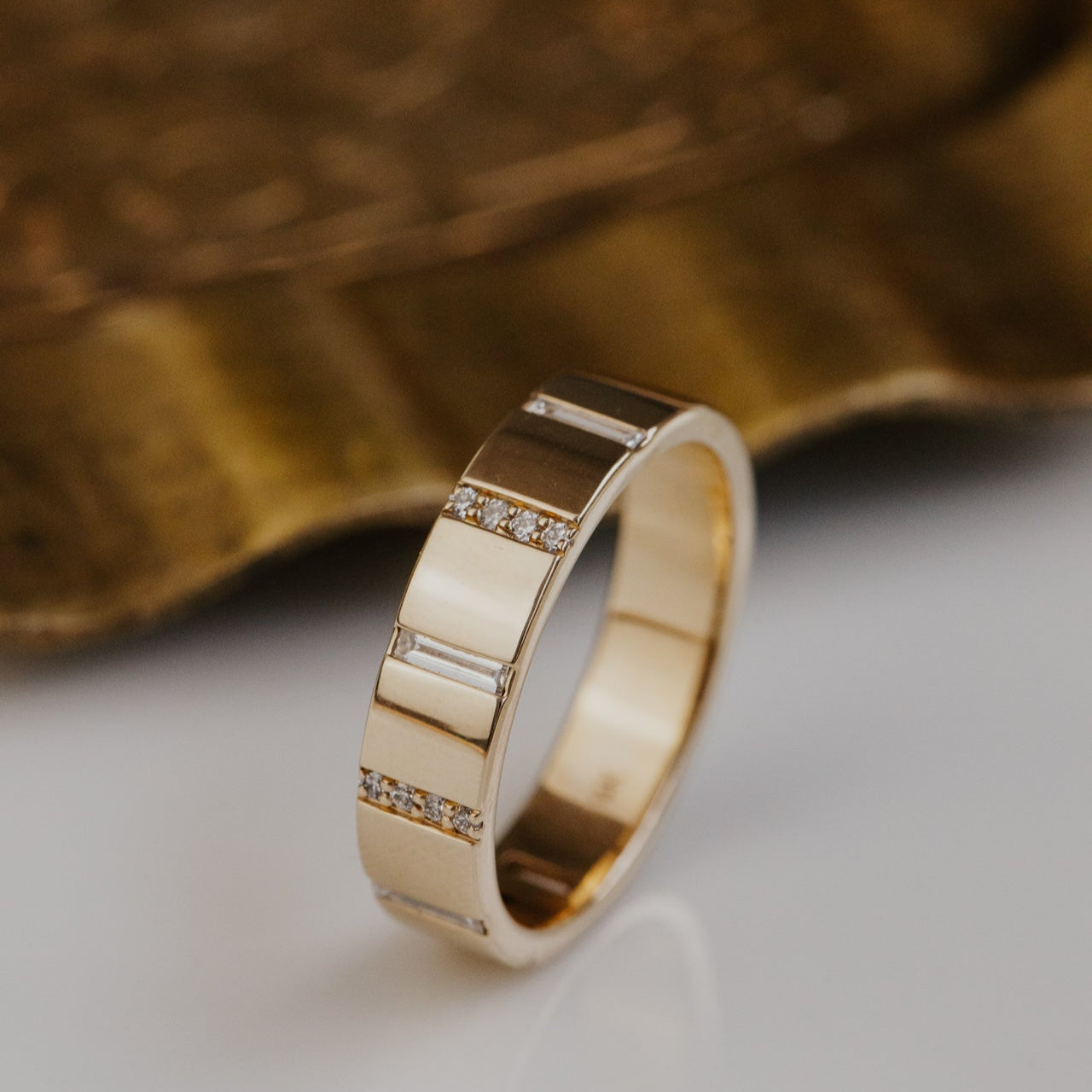 Gold wedding with diamond accents on a textured surface