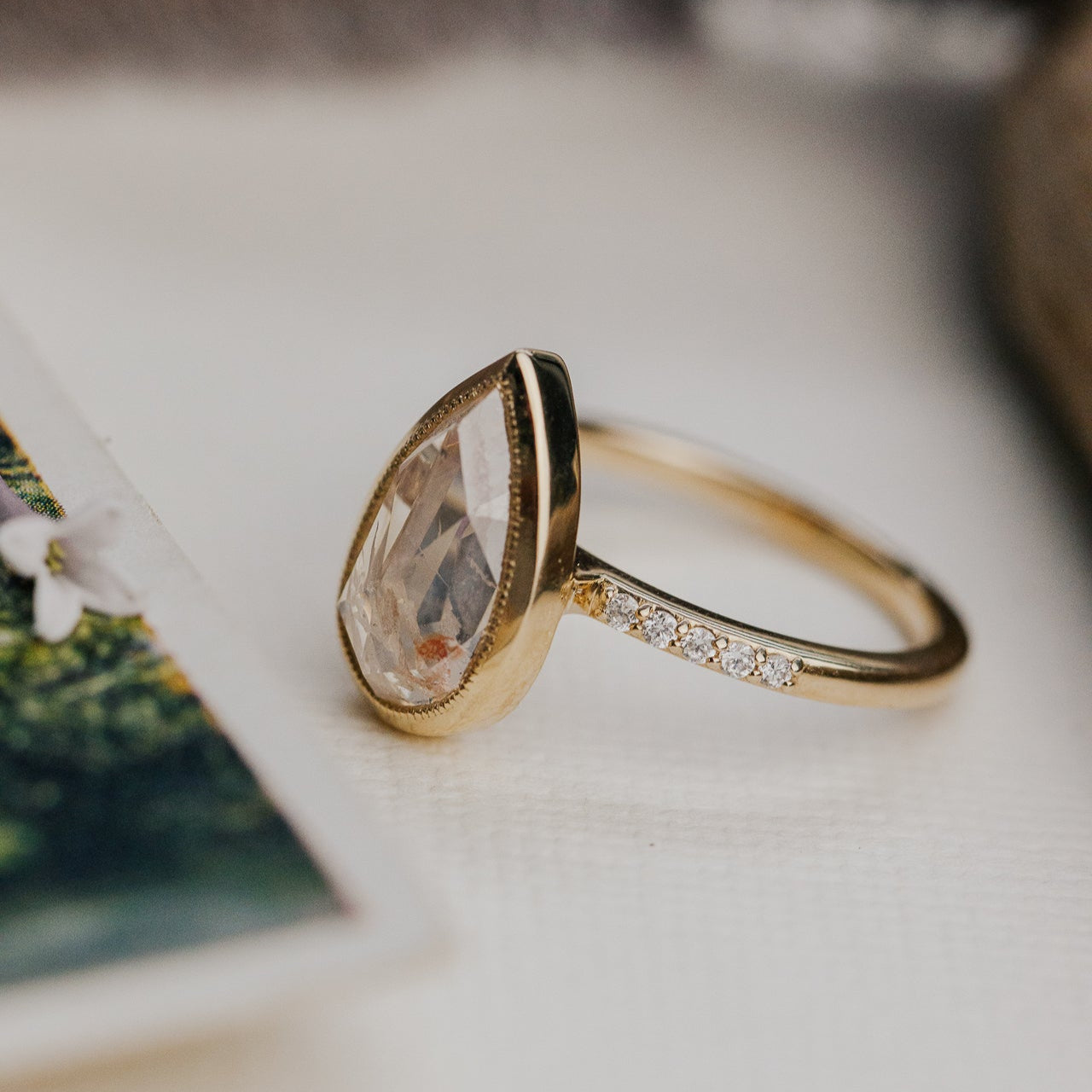 3.31 ct Pear Clear and Peach Rustic Diamond Ring in 14k yellow gold with a natural diamond band