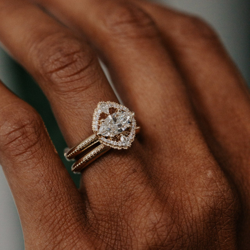 Rose gold ring with a large diamond on a person's finger