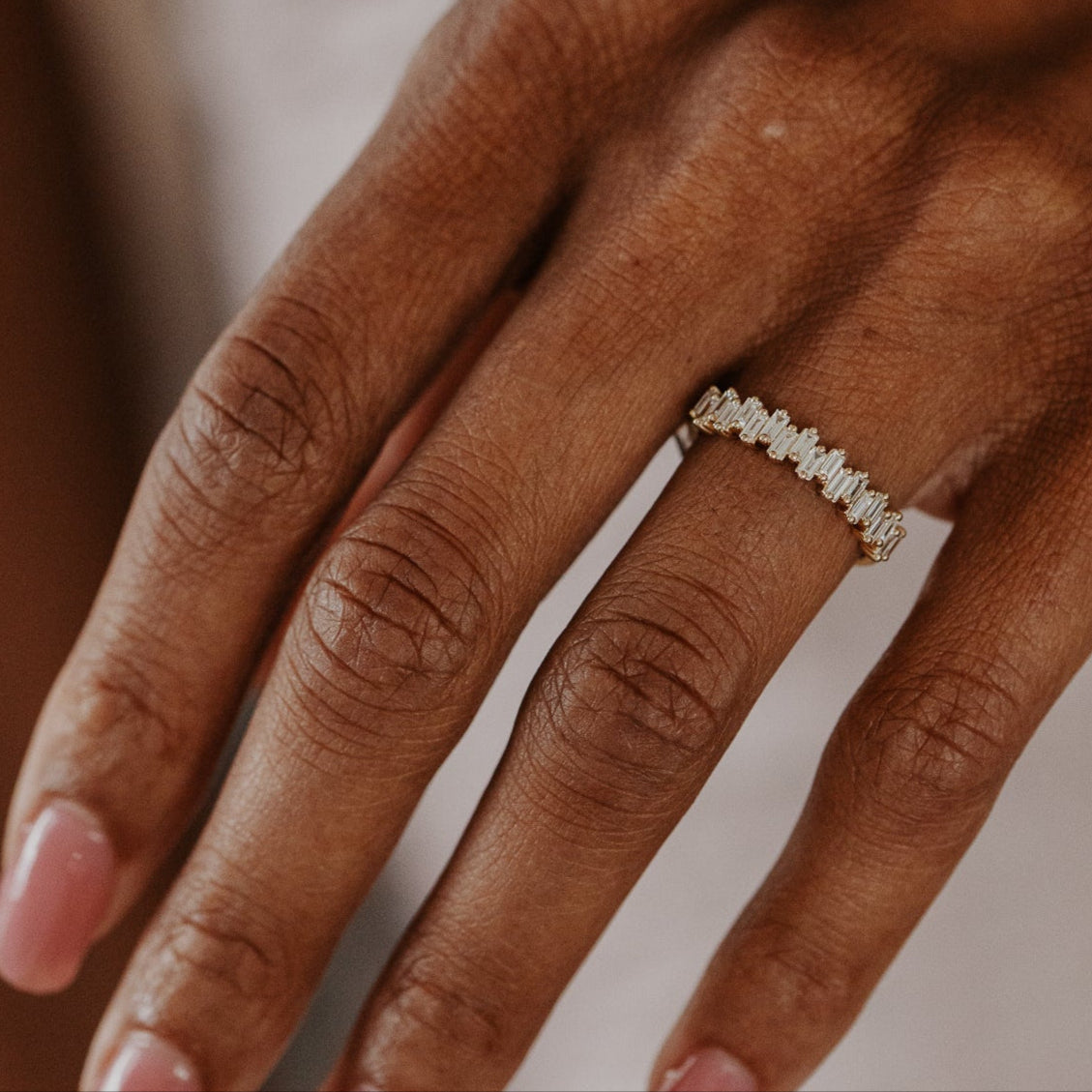 14k gold band featuring ~.48 cttw baguette diamonds set in a staggered design.