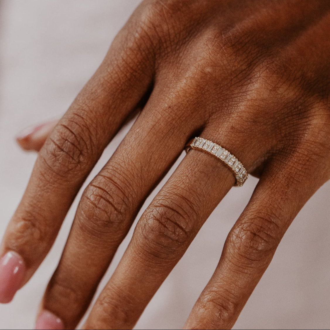 14k gold band featuring ~.49 cttw baguette and double round diamonds set in prongs in an alternating design