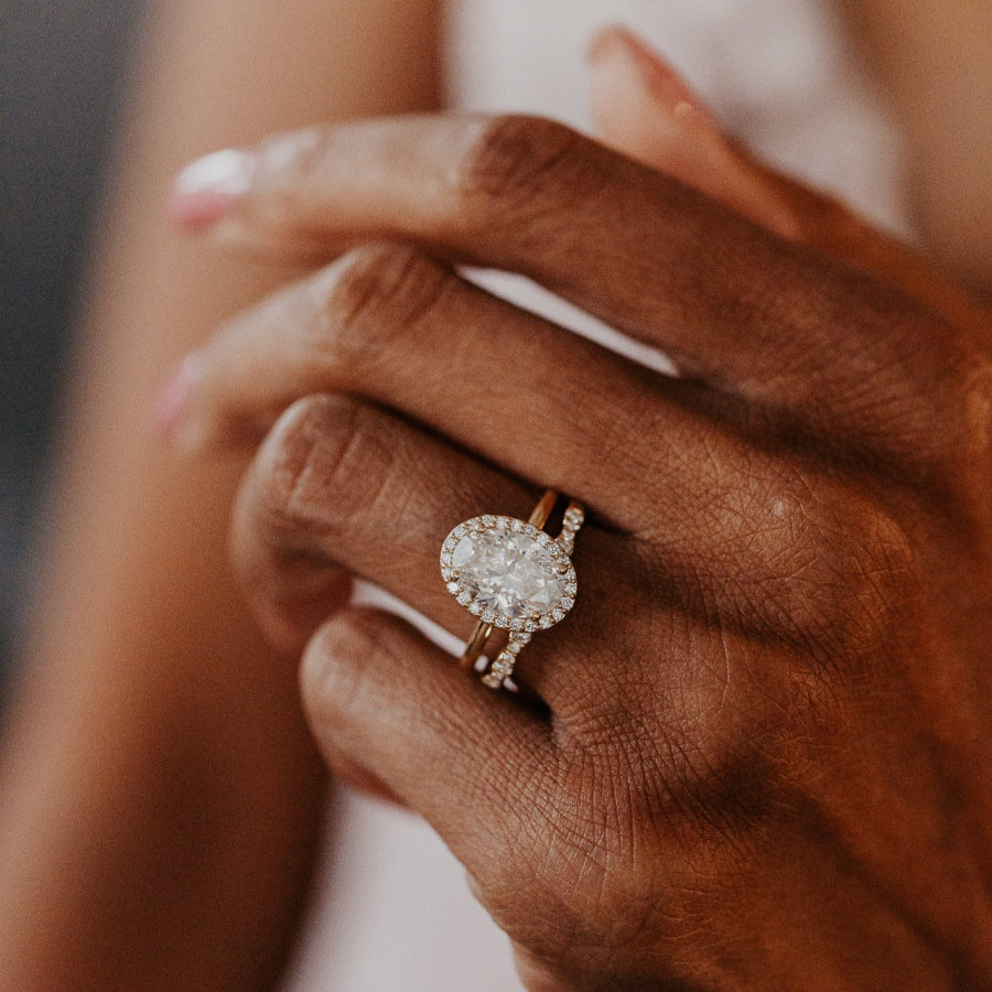 14k gold band  featuring ~.29 cttw pave round diamonds in a wave pattern paired with a oval diamond solitaire ring