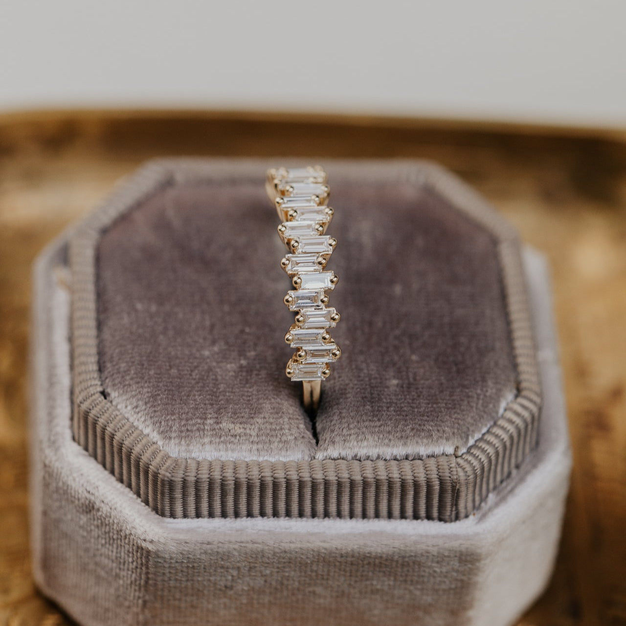 14k gold band featuring ~.48 cttw baguette diamonds set in a staggered design.