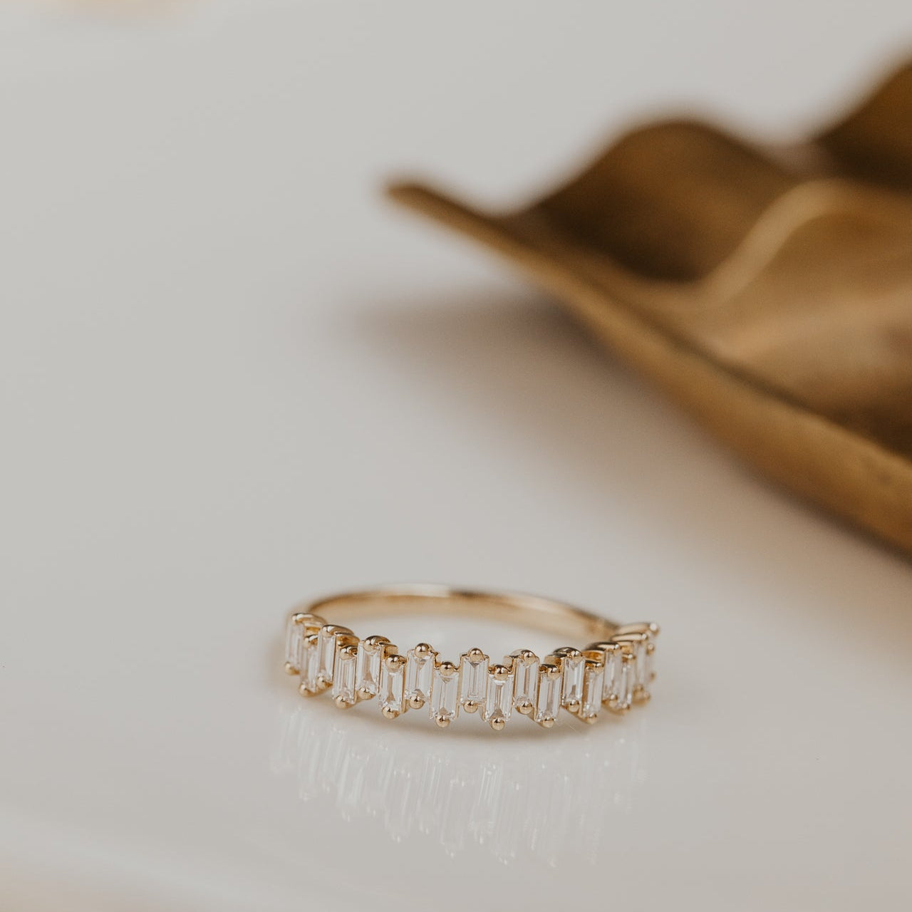 14k gold band featuring ~.48 cttw baguette diamonds set in a staggered design.