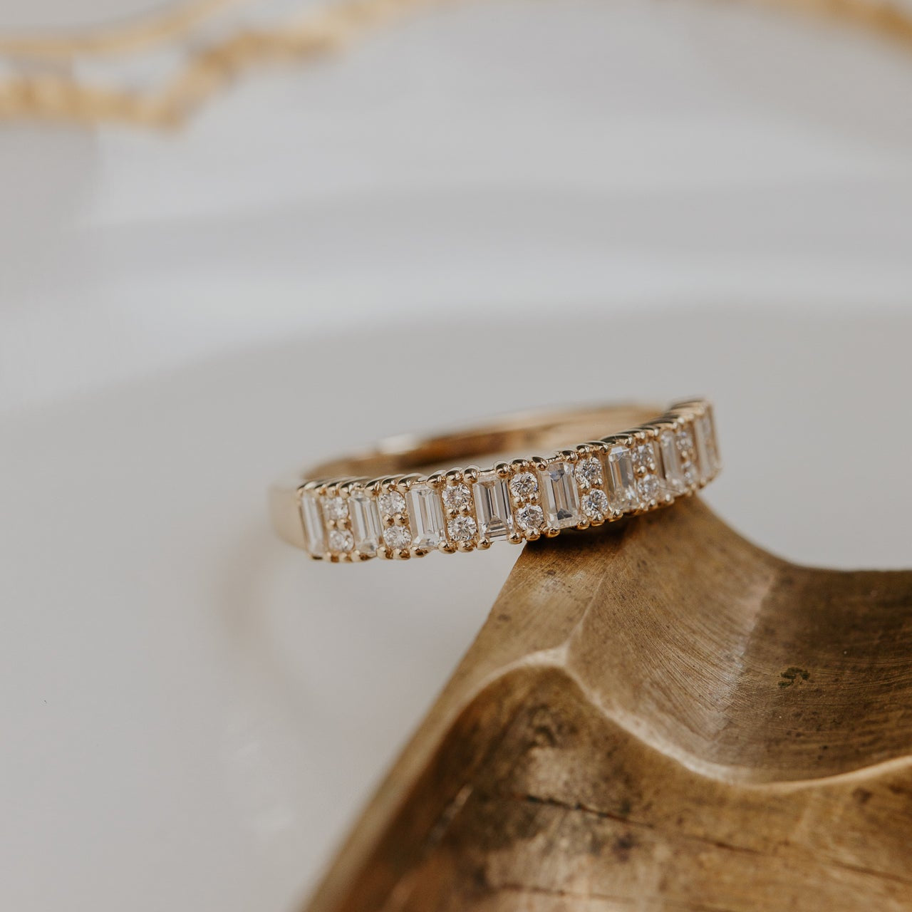 14k gold band featuring ~.49 cttw baguette and double round diamonds set in prongs in an alternating design
