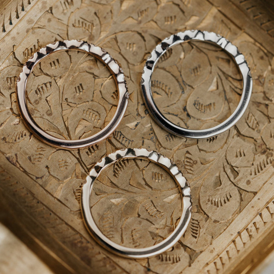 14k gold band  featuring ~.29 cttw pave round diamonds in a wave pattern