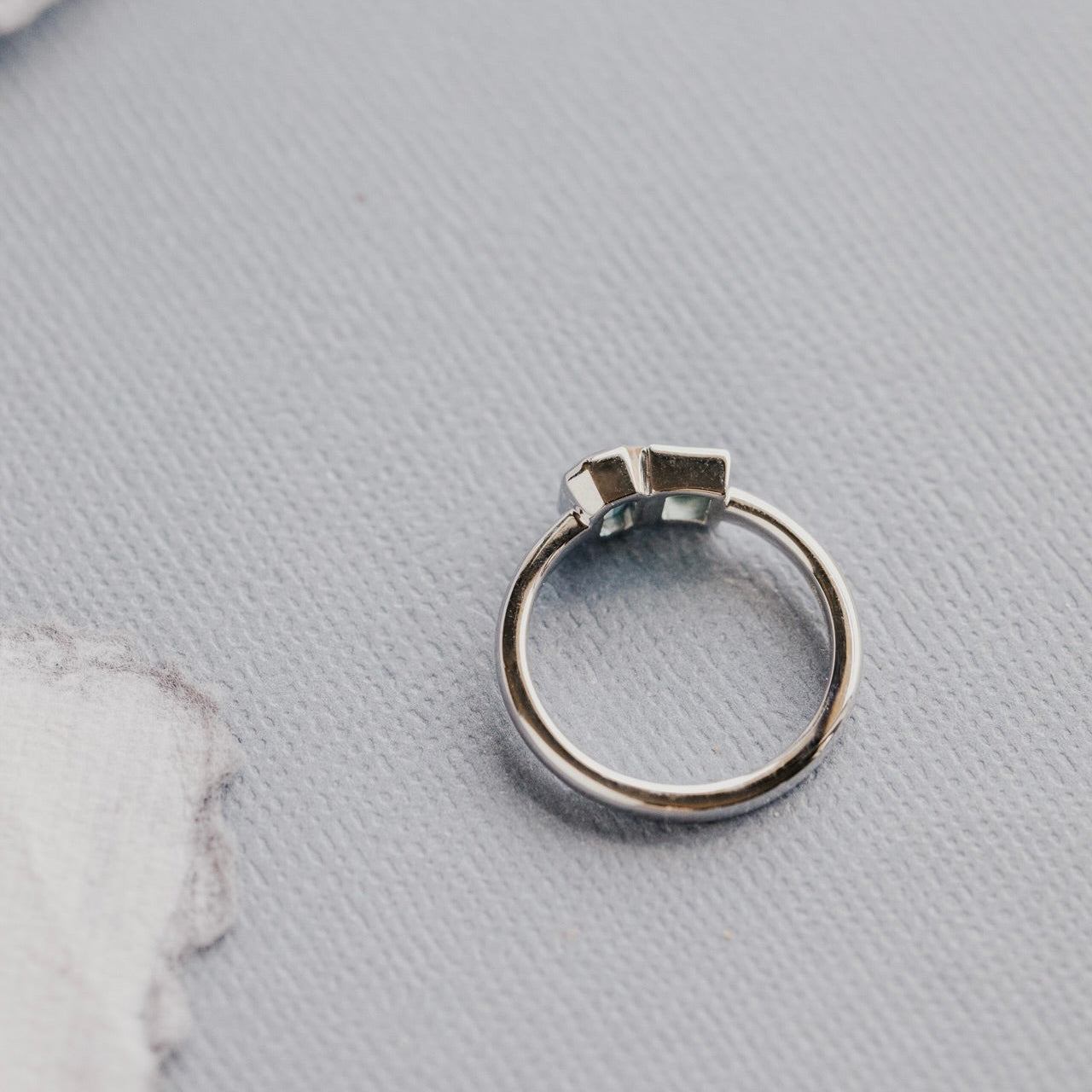 white gold ring on a textured gray surface