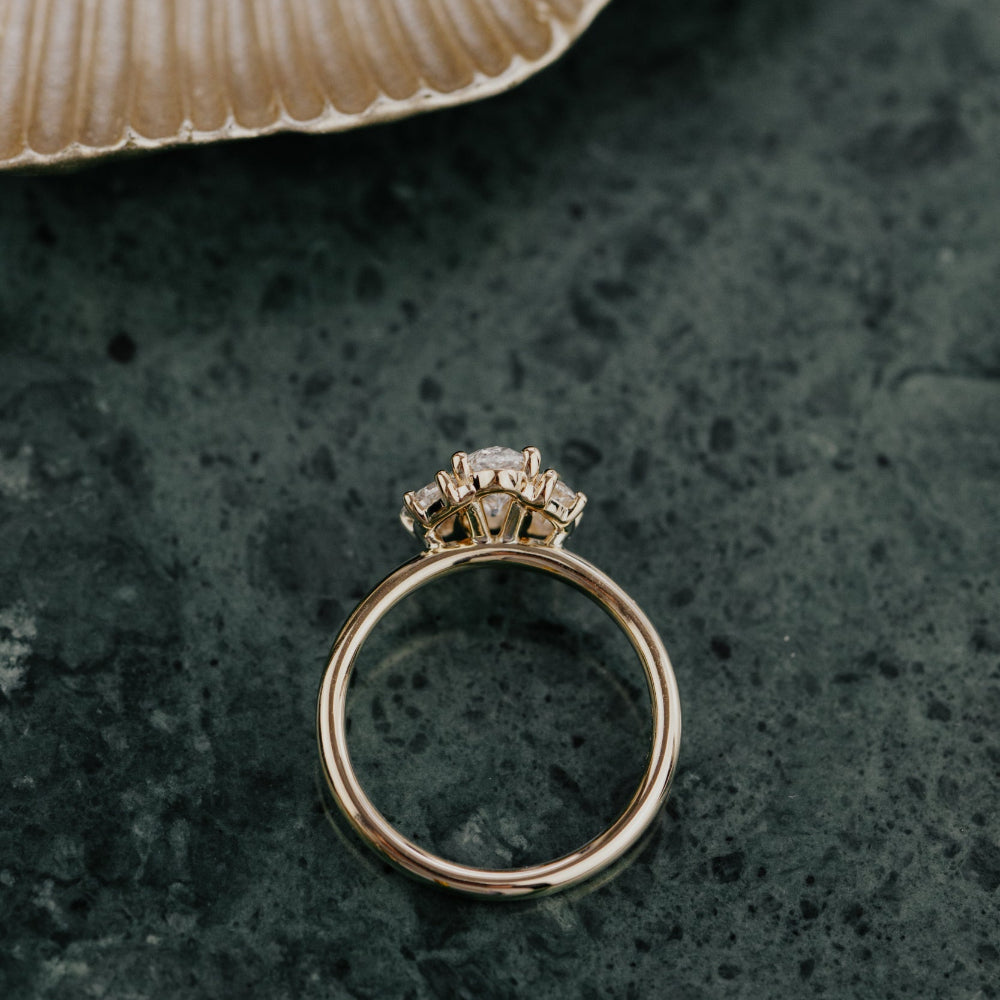 Gold ring with a diamond on a dark textured surface