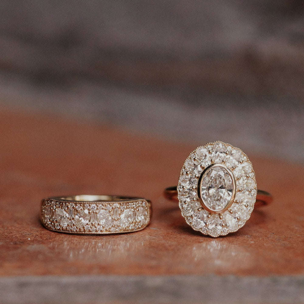 Two diamond rings on a textured surface with a blurred background