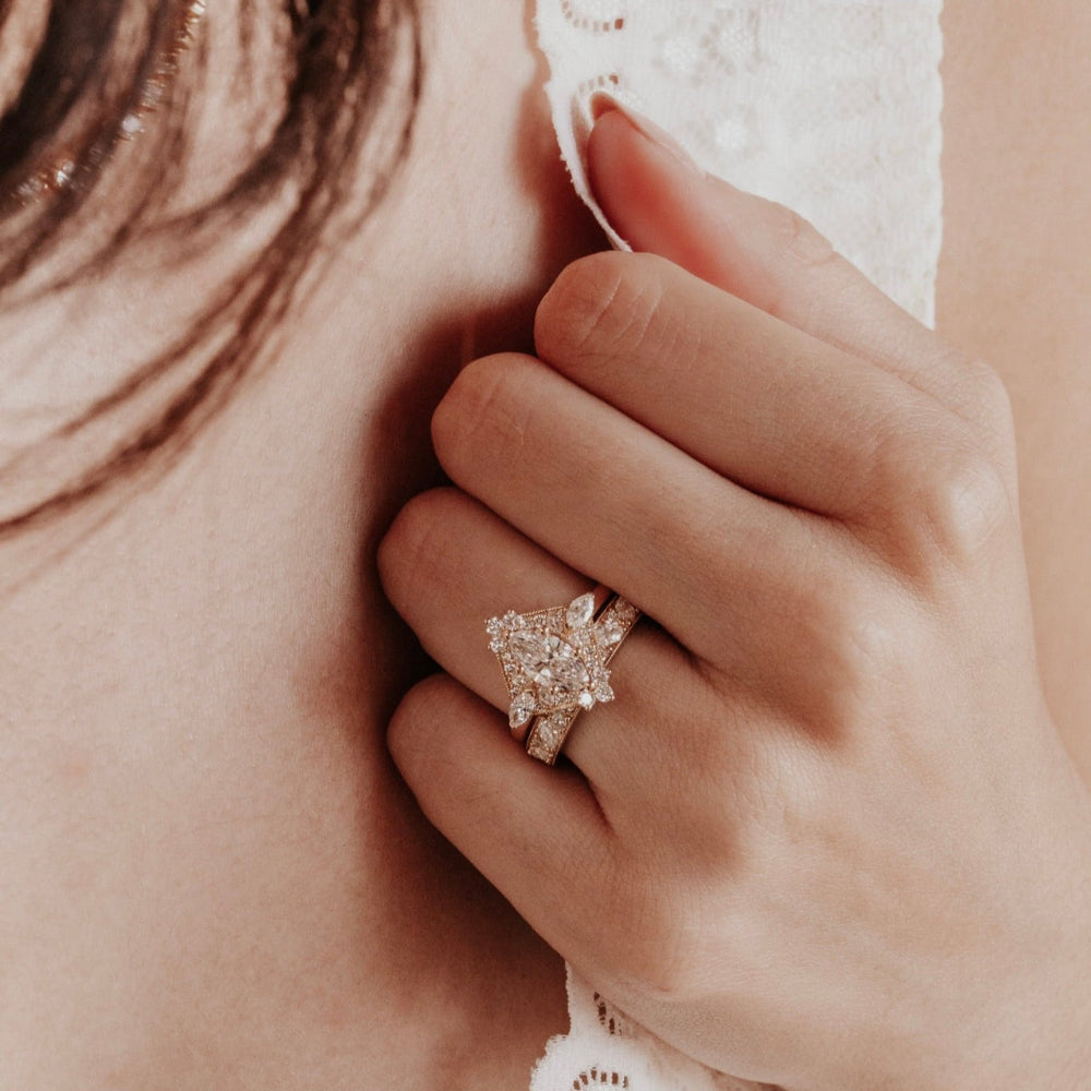 Close-up of a hand wearing a diamond ring with a blurred background