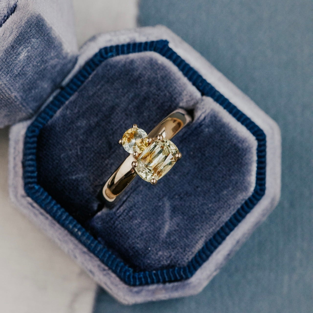 Gold ring with a Montana sapphire in a blue velvet box