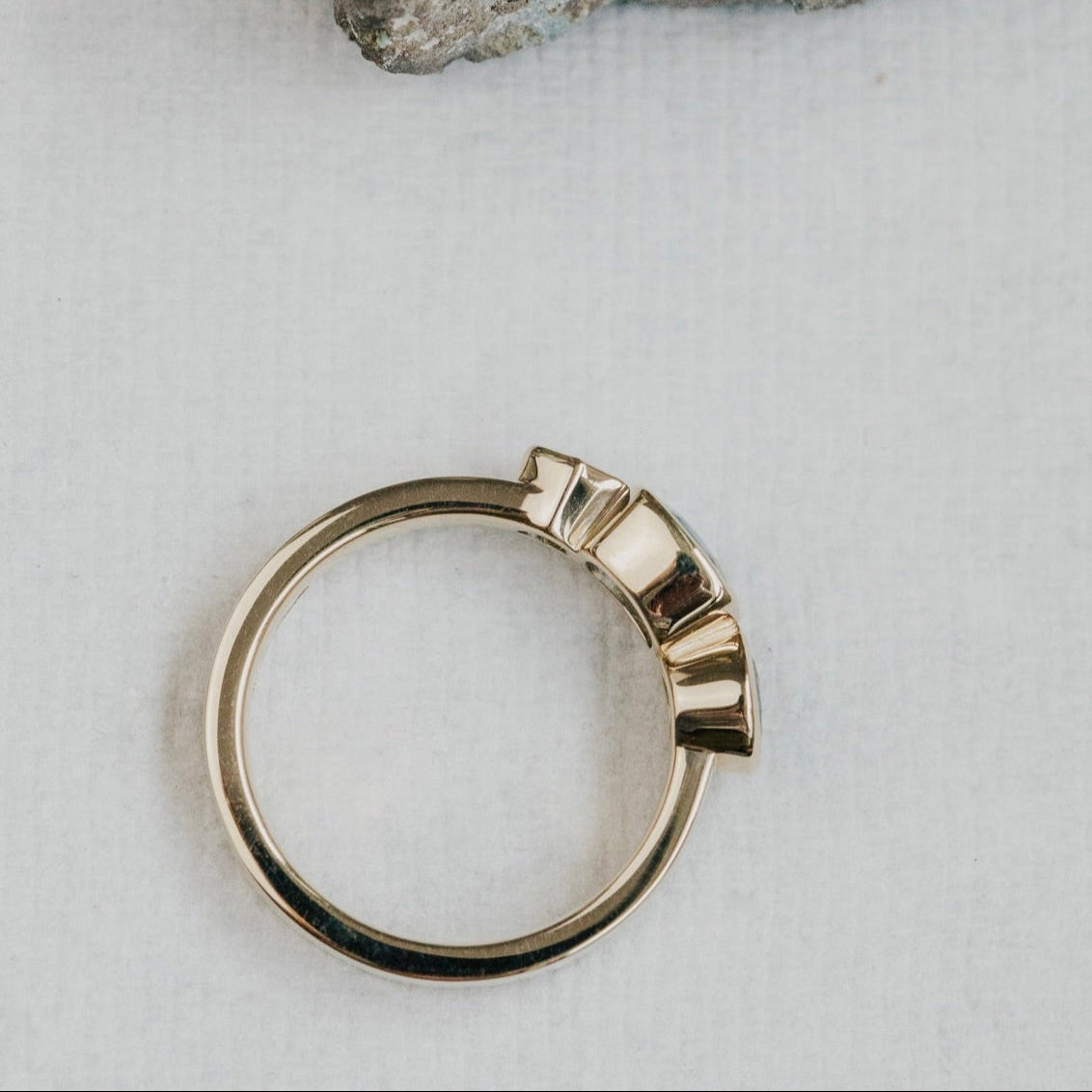 Gold ring with a stone background