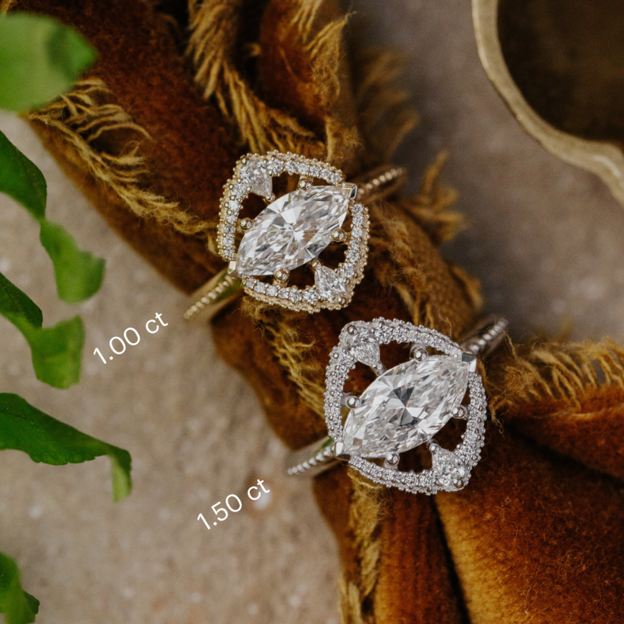Pair of diamond rings on a textured surface with text indicating stone weight.