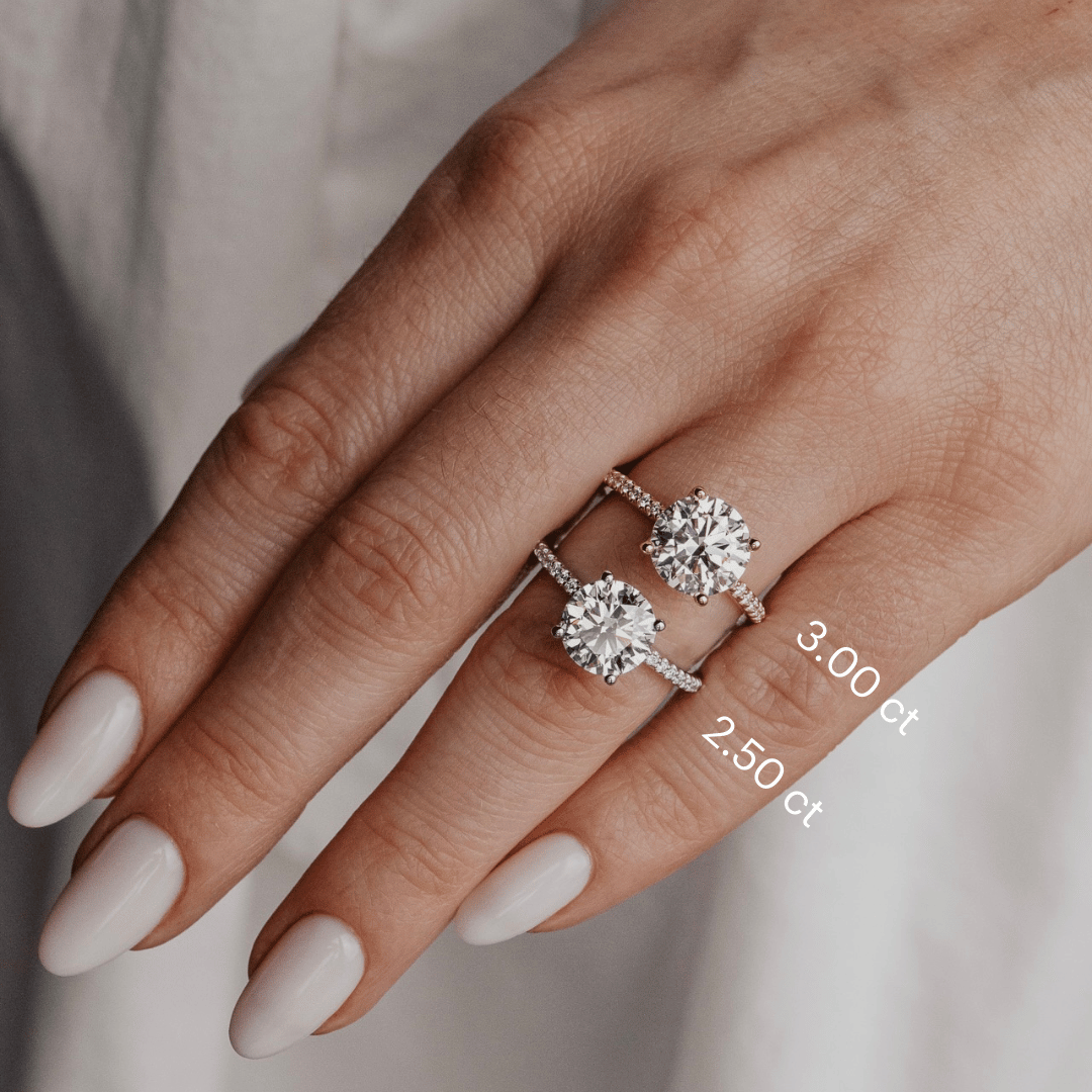 The Jenna Round Diamond Engagement Ring on a pave diamond band in 3 ct and 2.50 ct