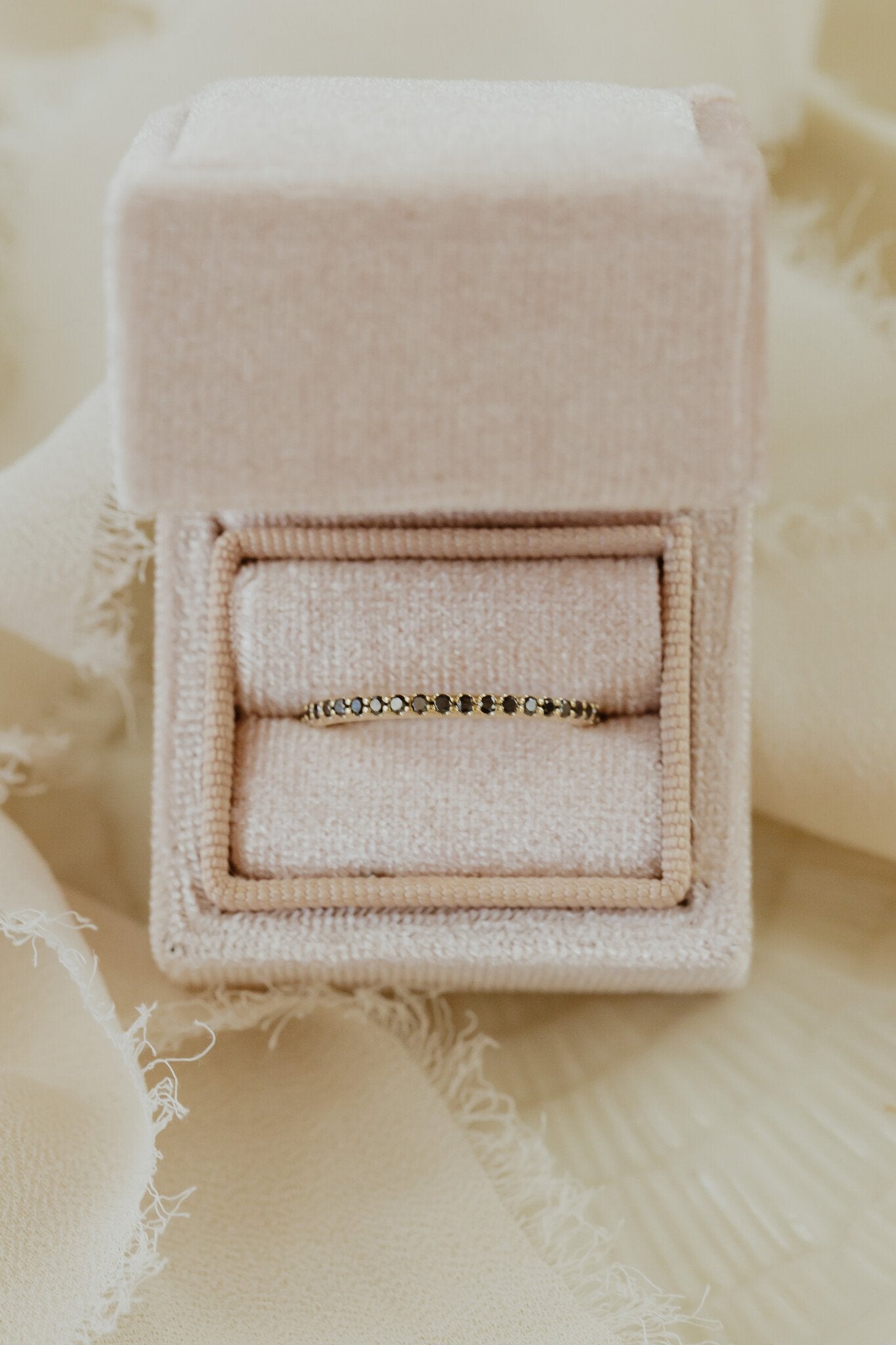 The Jenna Black Diamond Band in 14k yellow gold in a Sarah O Jewelry velvet ring box
