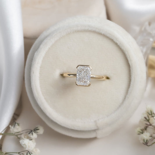 The Zadie Radiant Cut Half Bezel Solitaire Ring in a Sarah O Ring Box