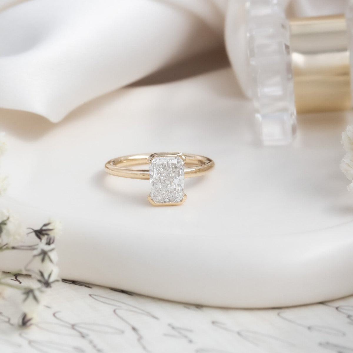 The Zadie Radiant Cut Half Bezel Solitaire Ring in 14k Yellow Gold