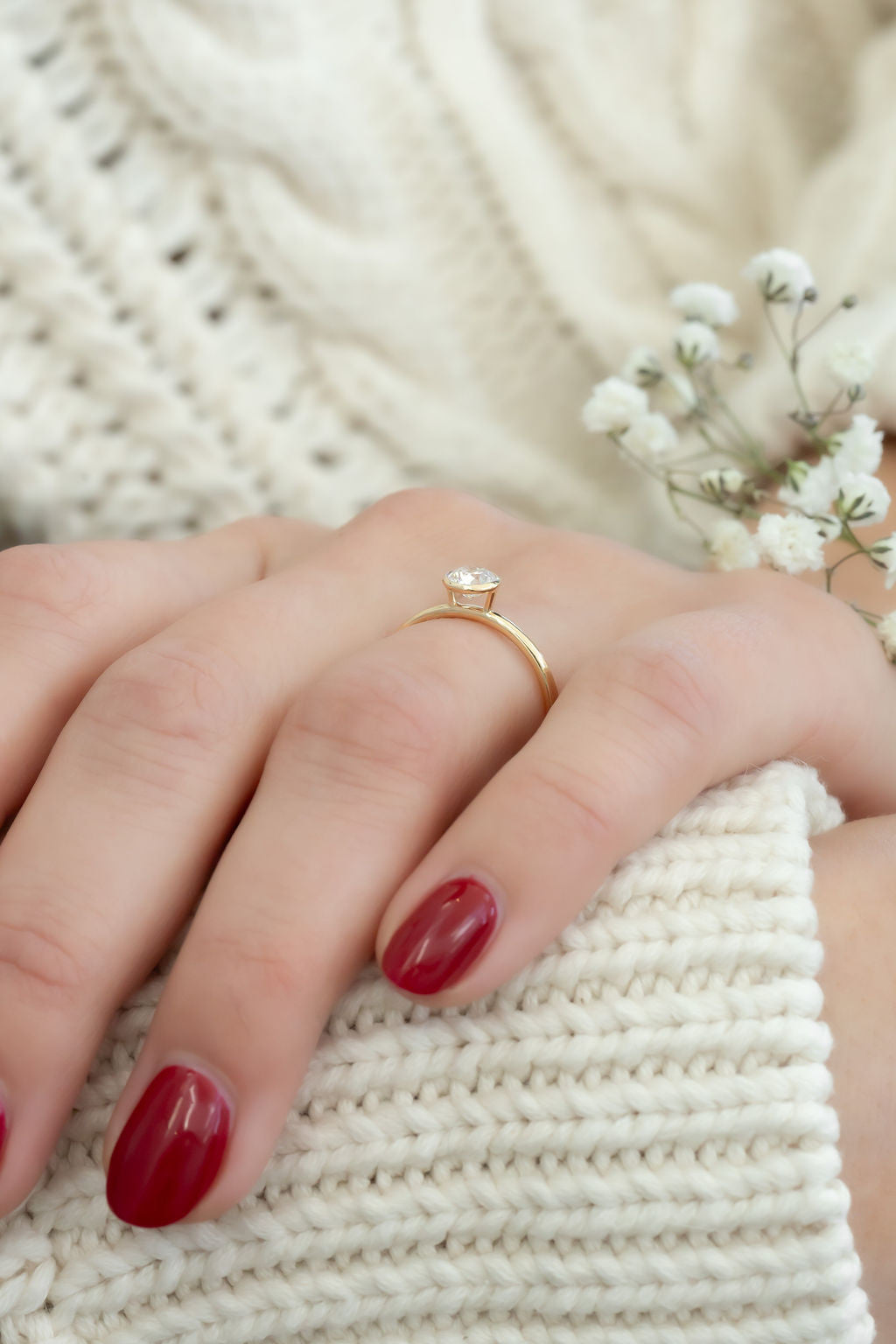 The Mini Bailey .50 ct Round Natural Solitaire side view on models hand