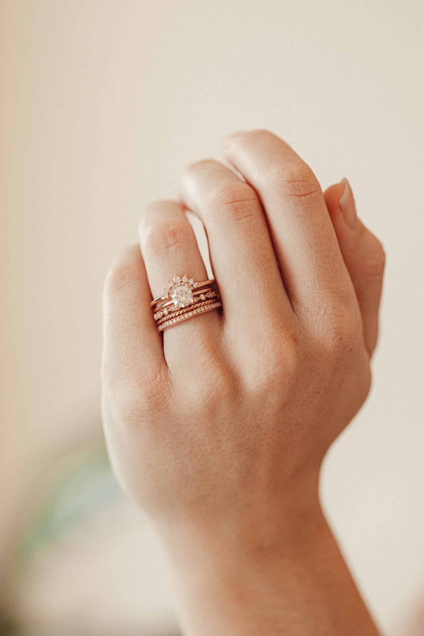 The Hazel Round Tracer Band paired with  Maeve Round Solitaire, The Pear and Round Band, The Skinny Rope Band, and The Single Row Diamond Band on a models hand