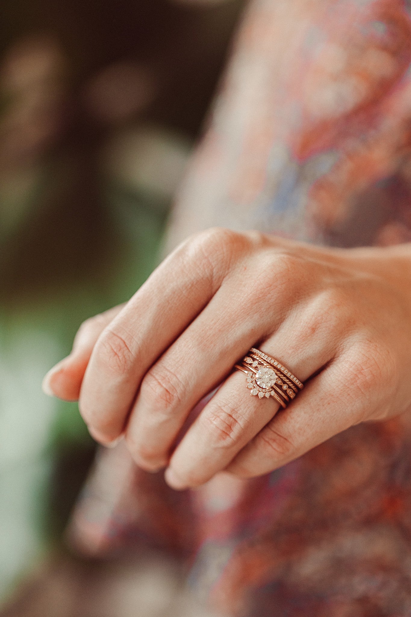The Hazel Round Tracer Band paired with  The Maeve Round Solitaire, The Pear and Round Band, The Skinny Rope Band, and The Single Row Diamond Band on a models hand.