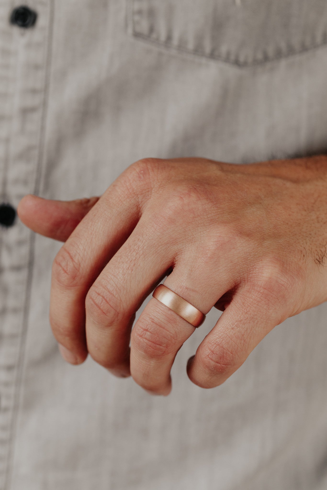 Close up of a man wearing the rose gold Colbie band.