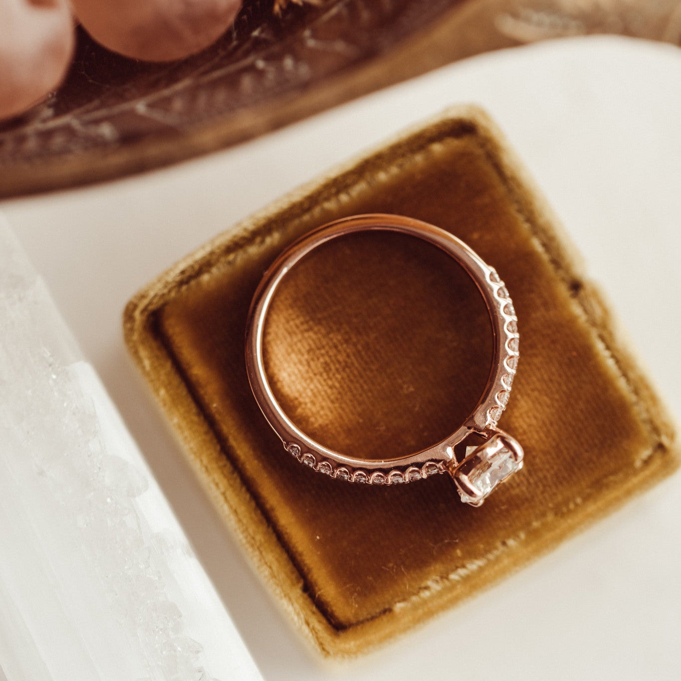 The Jenna Round Diamond Engagement Ring on a pave diamond band