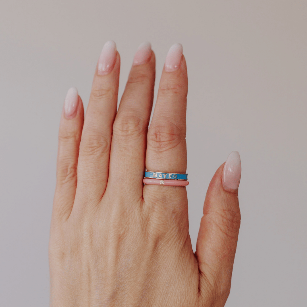 Multi Colored Enamel Rings stacked on a models hand.