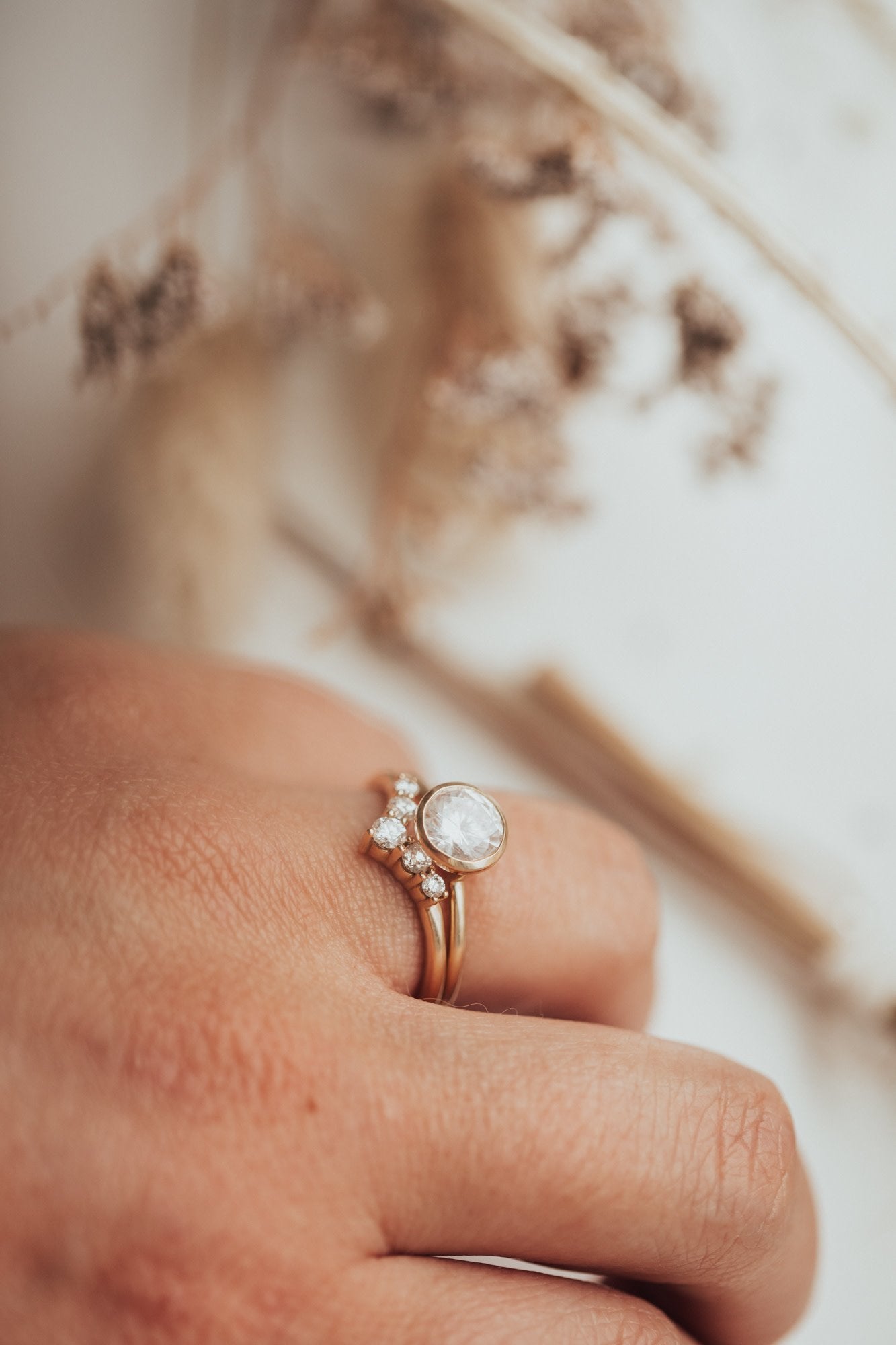 The Daisy Tracer Band on a models hand paired with The Bailey Round Solitaire.
