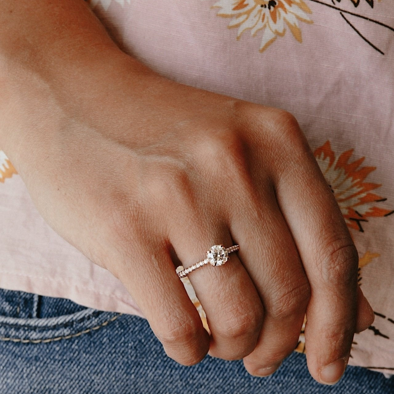 The Jenna Round Diamond Engagement Ring on a pave diamond band