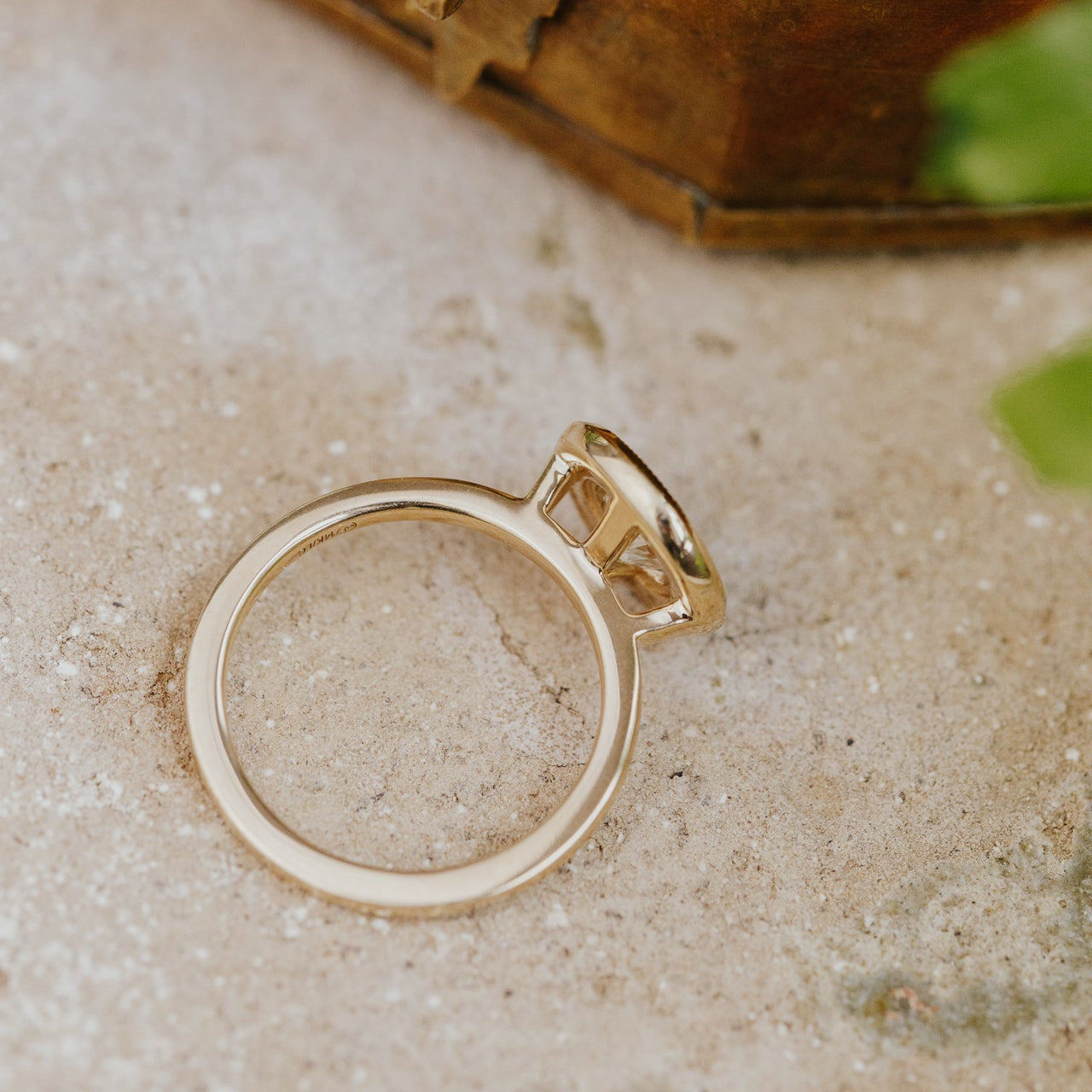 Gold ring on a textured surface with a natural background
