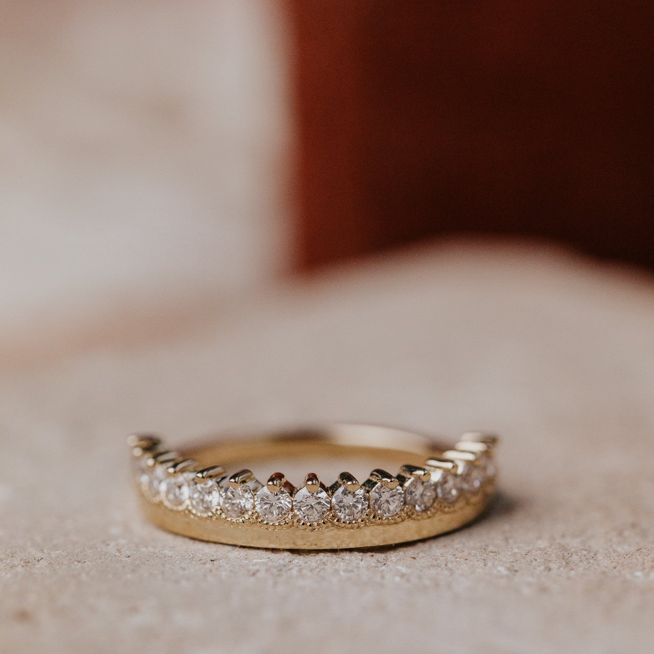 Gold ring with diamonds on a soft background