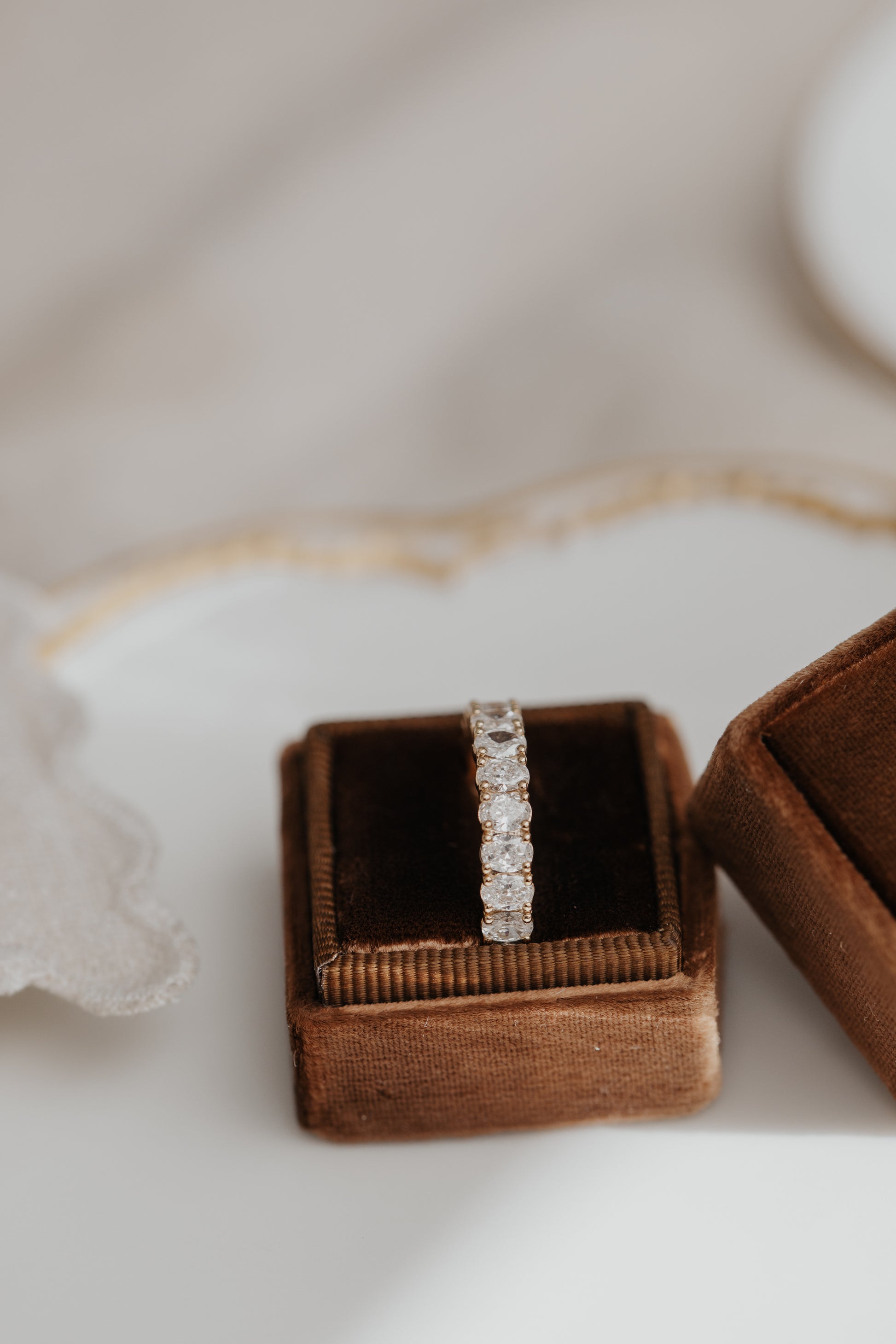 The Amara Oval 3/4 Diamond Band in a Sarah O Jewelry ring box