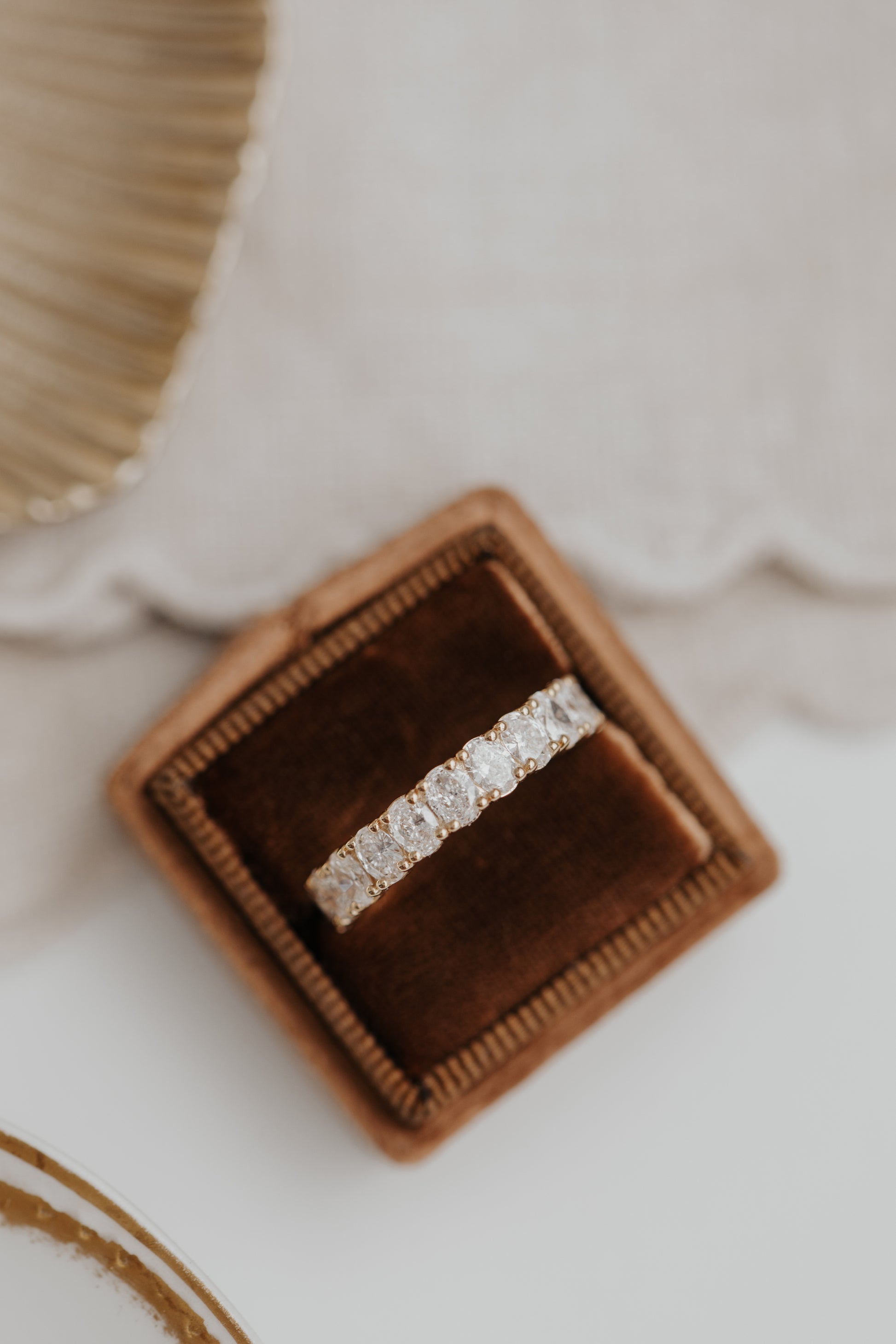 The Amara Oval 3/4 Diamond Band in a Sarah O Jewelry ring box