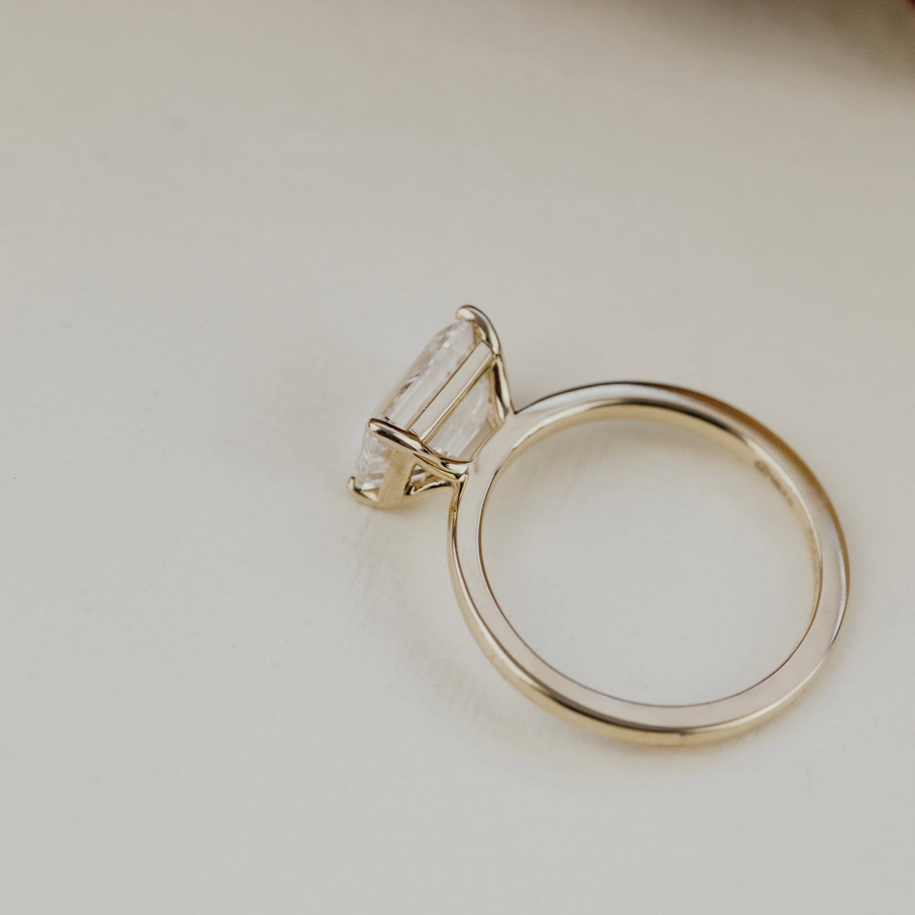 The Bennett 2.52 ct emerald cut lab grown on a light beige background