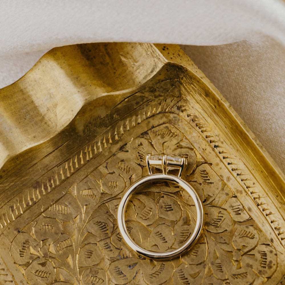Gold ring on a textured gold surface.
