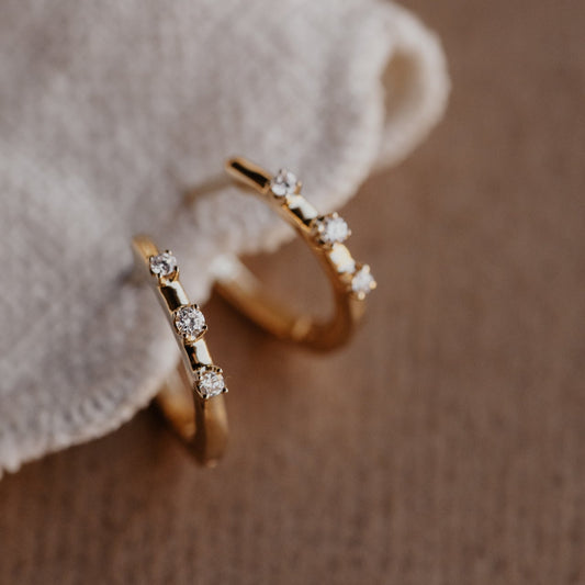 Three Prong Set Round Diamonds on Huggie Earrings in 14 yellow gold