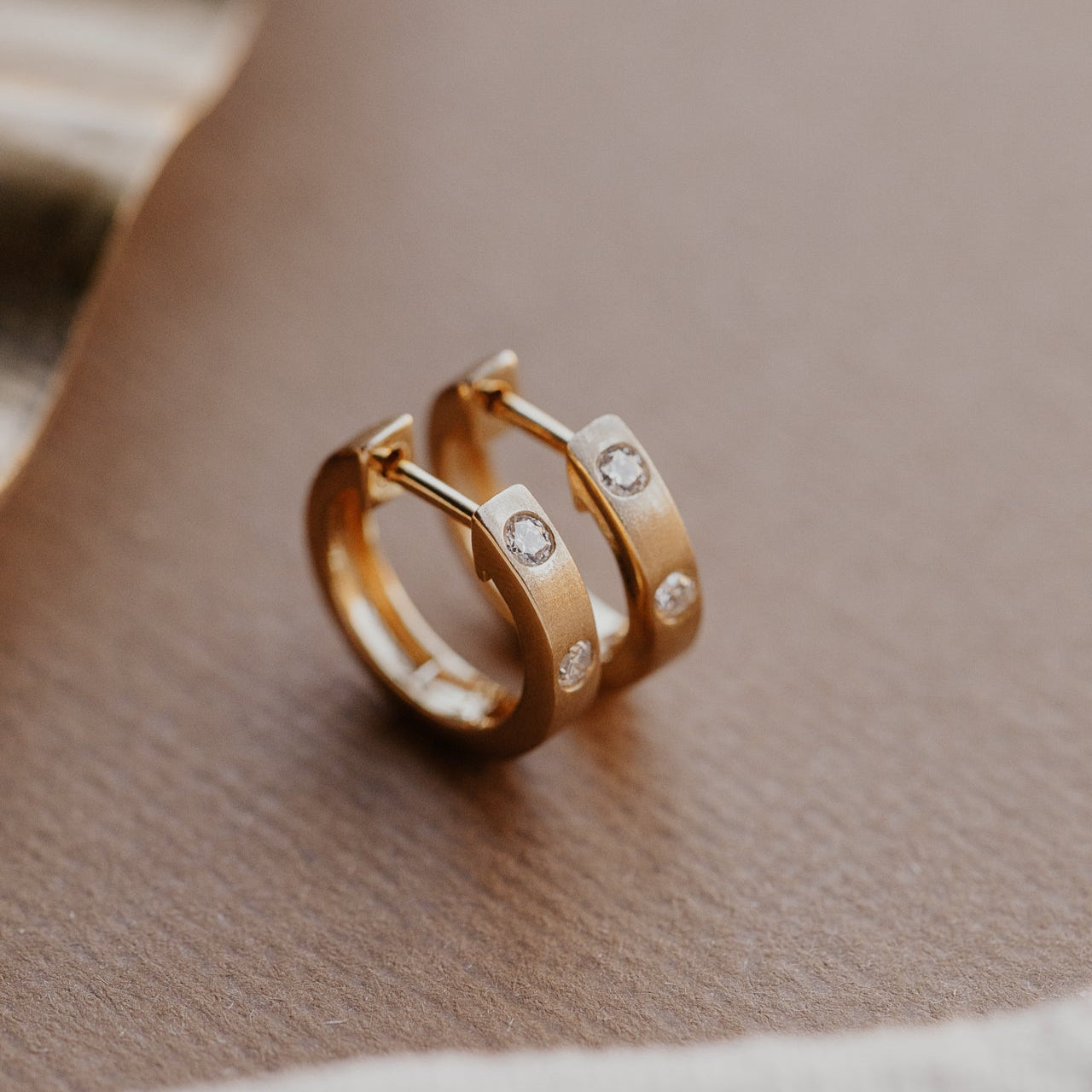 Profile view of the Three Hammer Set Round Diamonds on Hoop Earrings