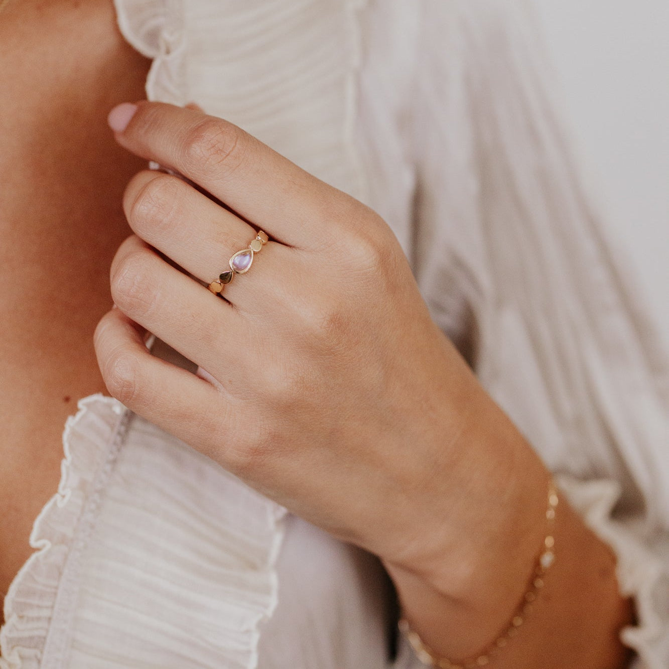 Close-up of a hand wearing a ring with a blurred background